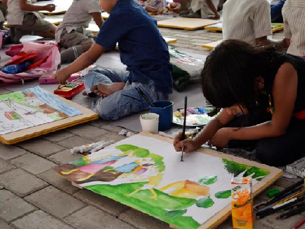 A girl painting at Children's Biennale