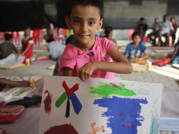 A child with his painting at Kochi Muziris Biennale